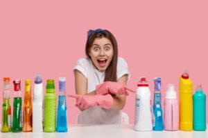 indoor-shot-happy-european-lady-with-overjoyed-expression-keeps-mouth-opened-crosses-hand-indicates-two-sides-detergents